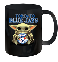 Baby Yoda Hugs Loves The Toronto Blue Jays Baseball Ceramic Mug 11oz Ceramic Mug 11oz - VeigarTee