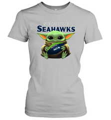 Baby Yoda Loves The Seattle Seahawks Star Wars Baby Yoda Hugs Seahawks NFL Womens T-Shirt Womens T-Shirt - VeigarTee