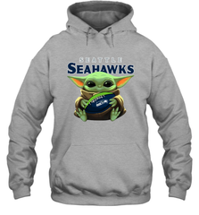 Baby Yoda Loves The Seattle Seahawks Star Wars Baby Yoda Hugs Seahawks NFL Adult Hoodie Sweatshirt Adult Hoodie Sweatshirt - VeigarTee